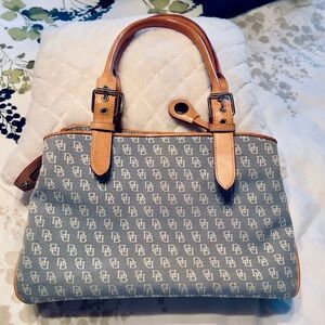 Dooney & Bourke satchel style logo fabric with tan leather handles and piping.